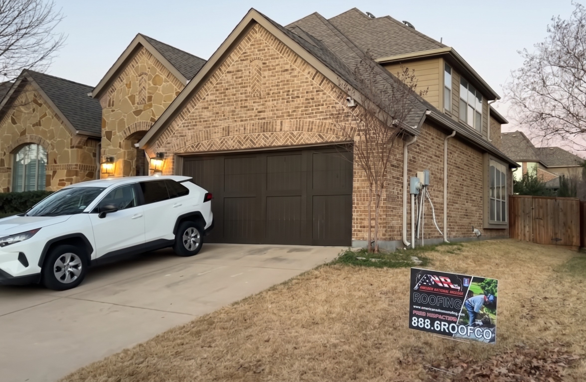 Ground-level view of a home with a brand new roof completed by American National Roofing, with our yard sign in the front yard