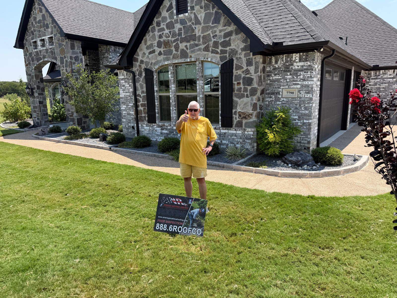Happy customer giving a thumbs up in front of a new roof in Fort Worth